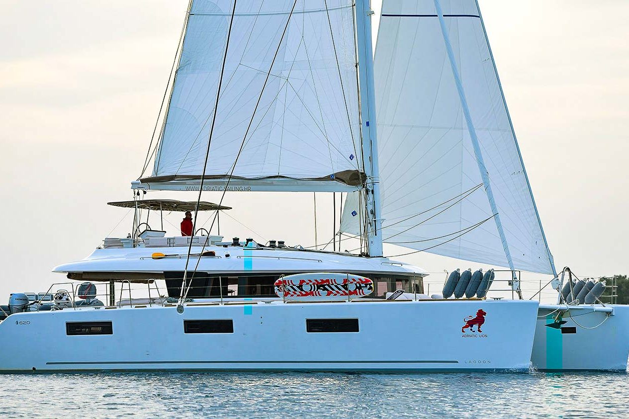 This is photo of a catamaran Lagoon 620 at anchor