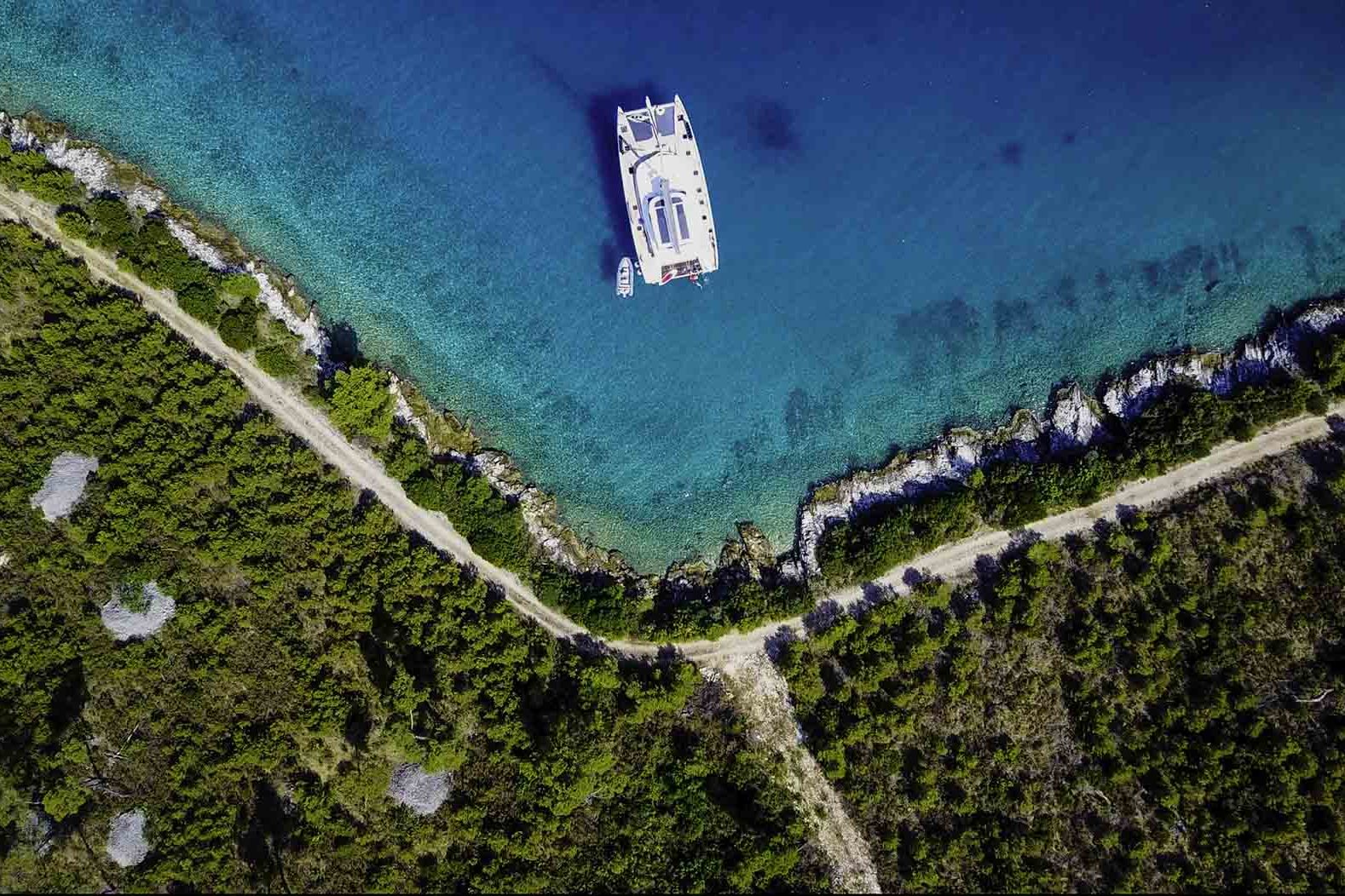 This is photo of a catamaran Lagoon 77 named Adriatic Dragon aerial view