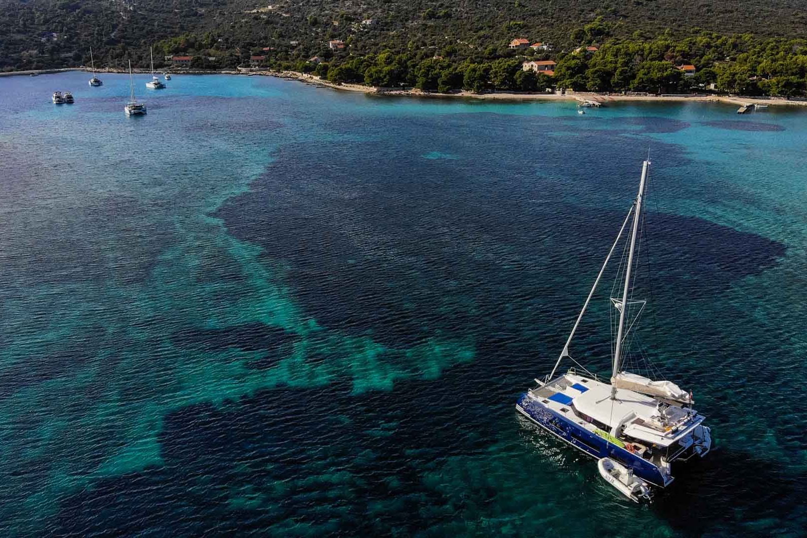 This is photo of a Dufour 48 Catamaran at anchor